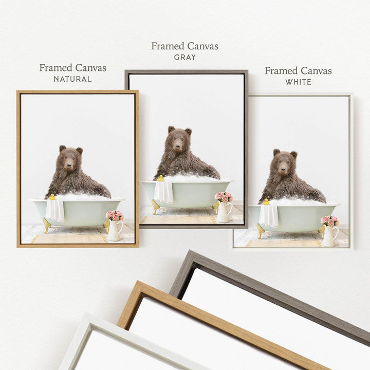 a brown bear sitting in a bathtub, surrounded by various framed artworks.