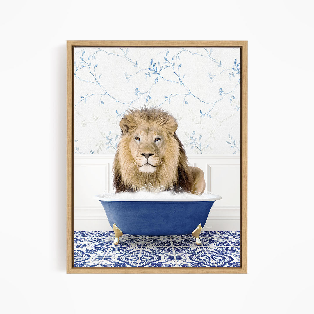 A lion sitting in a blue bathtub filled with bubbles, with a blue and white floral patterned wall behind it.