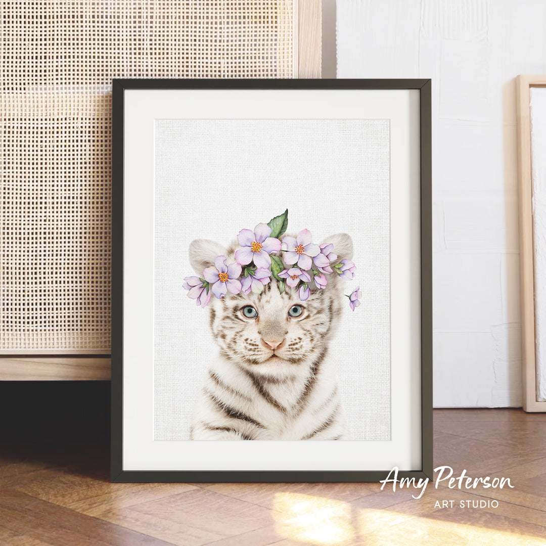 A framed print of a tiger wearing a flower crown, with a white background and purple flowers.