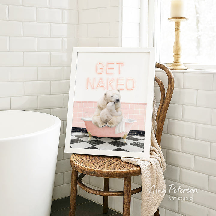 A framed image of a polar bear sitting in a bathtub, with the text "GET NAKED" displayed on the frame.