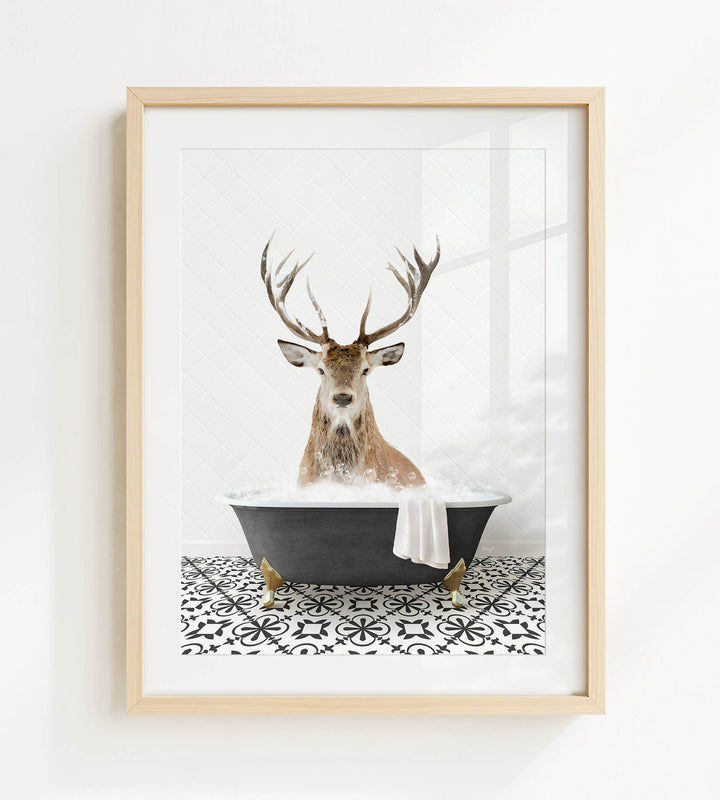 A deer with large antlers is sitting in a black bathtub filled with bubbles, creating a whimsical and unexpected scene.