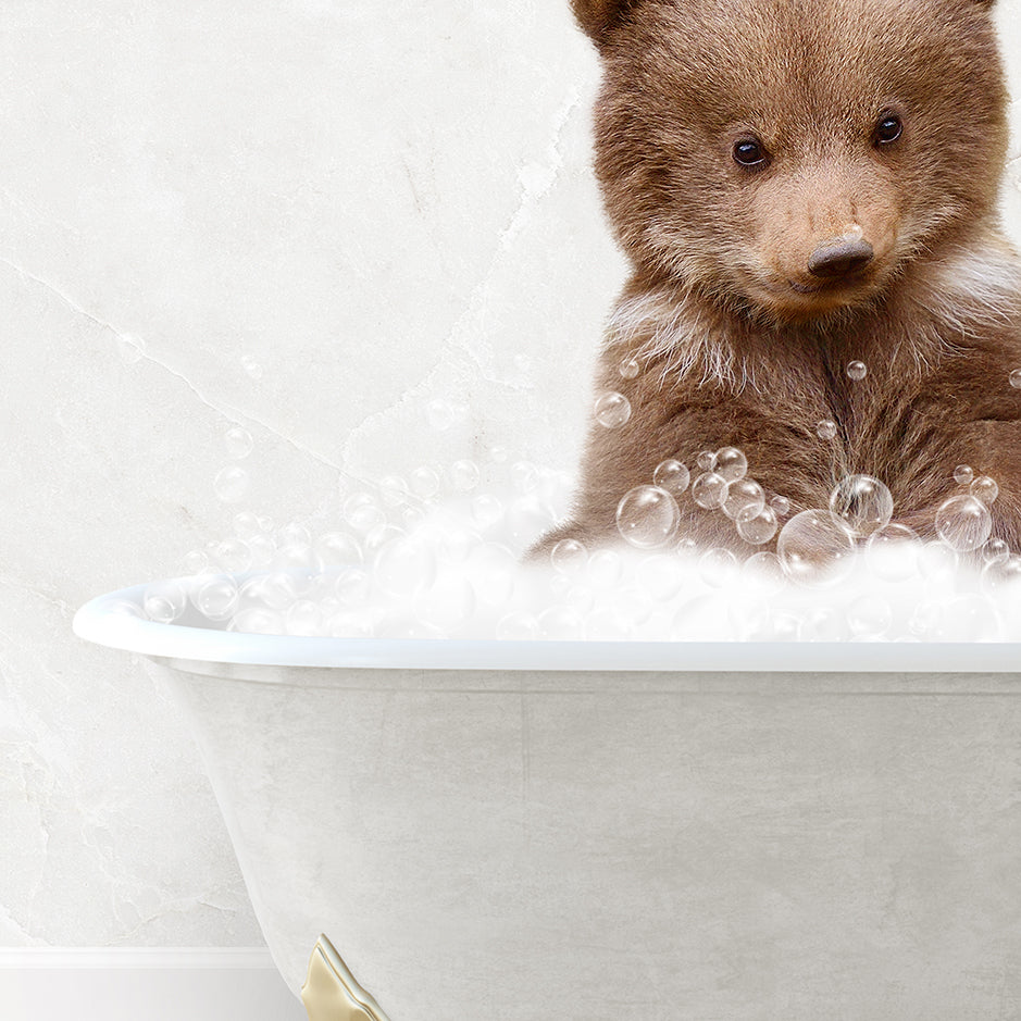 a brown bear sitting in a bathtub filled with bubbles