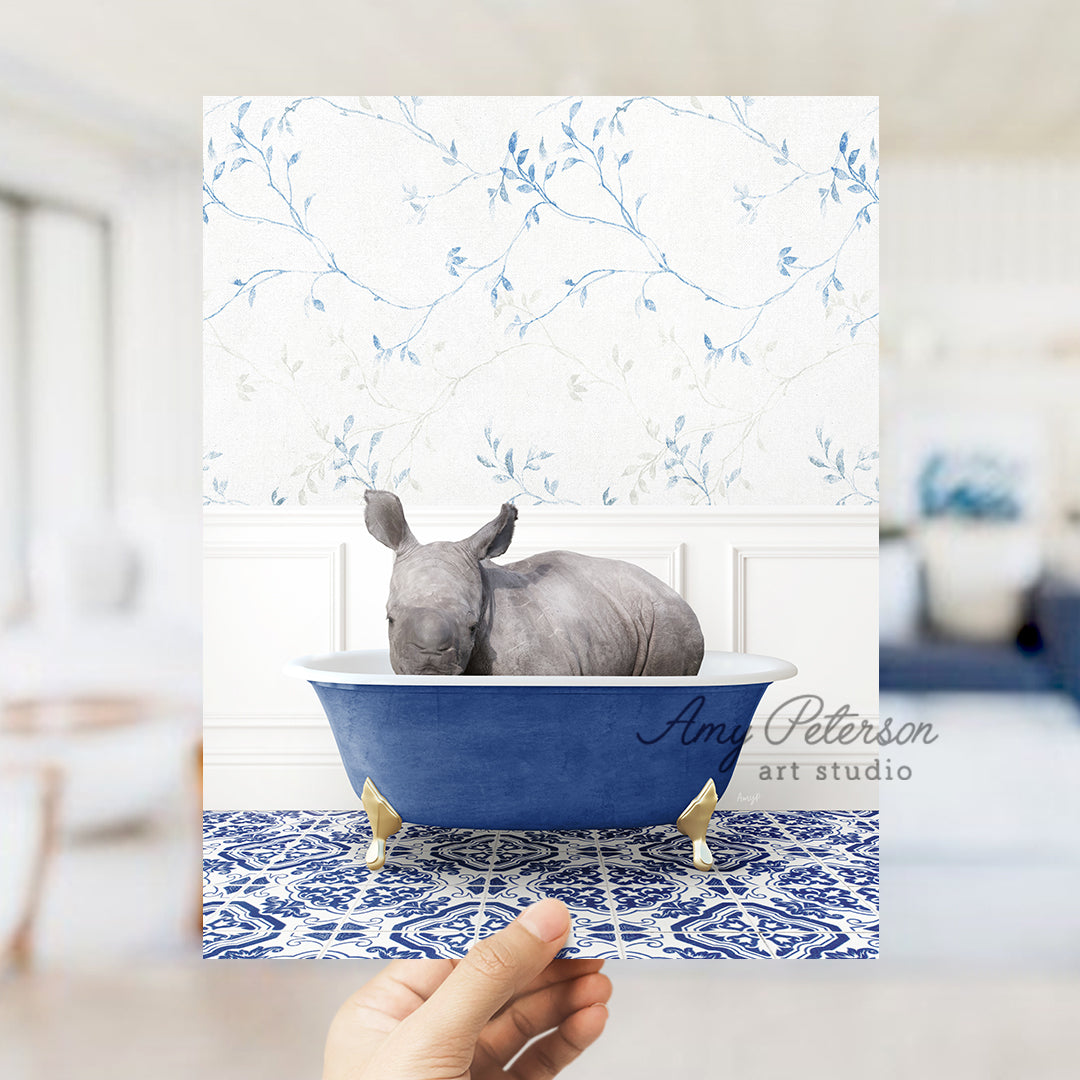 a hand holding up a card with a picture of a rhino in a bathtub