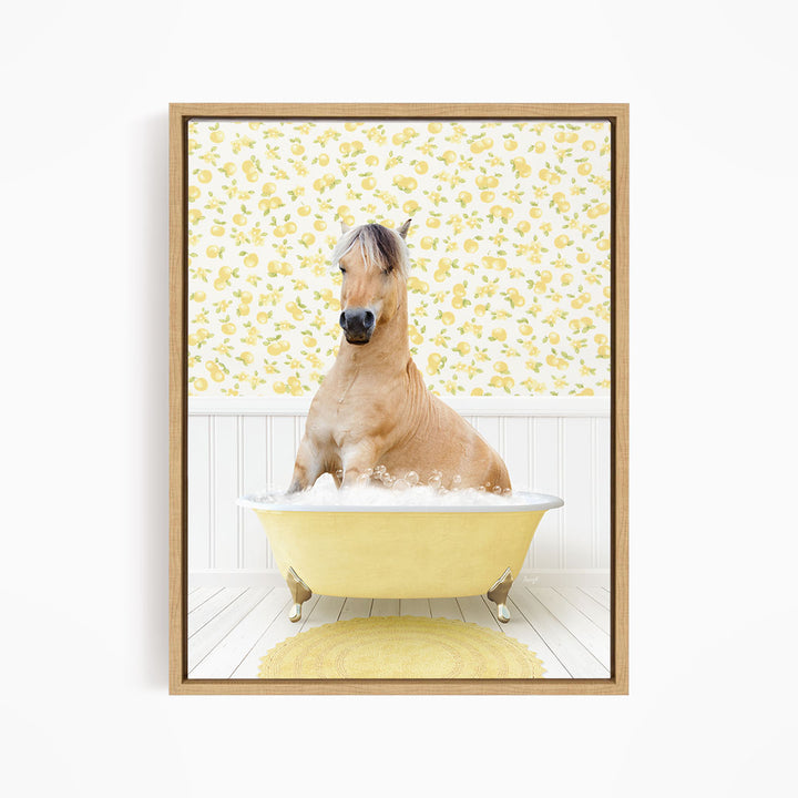A light brown horse is sitting in a yellow bathtub filled with water, surrounded by a yellow floral pattern on the wall behind it.