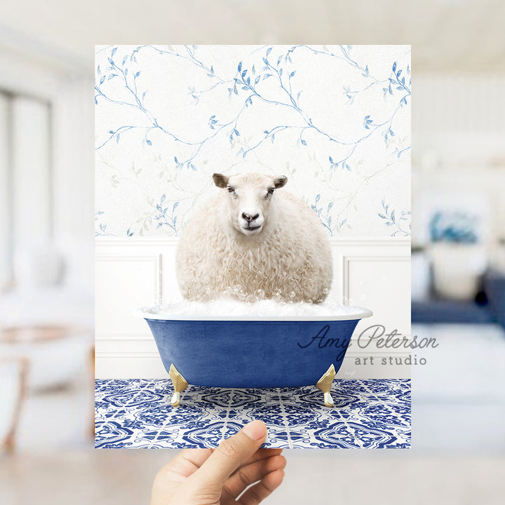 a hand holding a card with a sheep in a bathtub