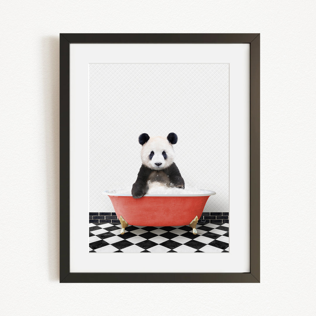 A panda bear sitting in a red bathtub on a black and white checkered floor.