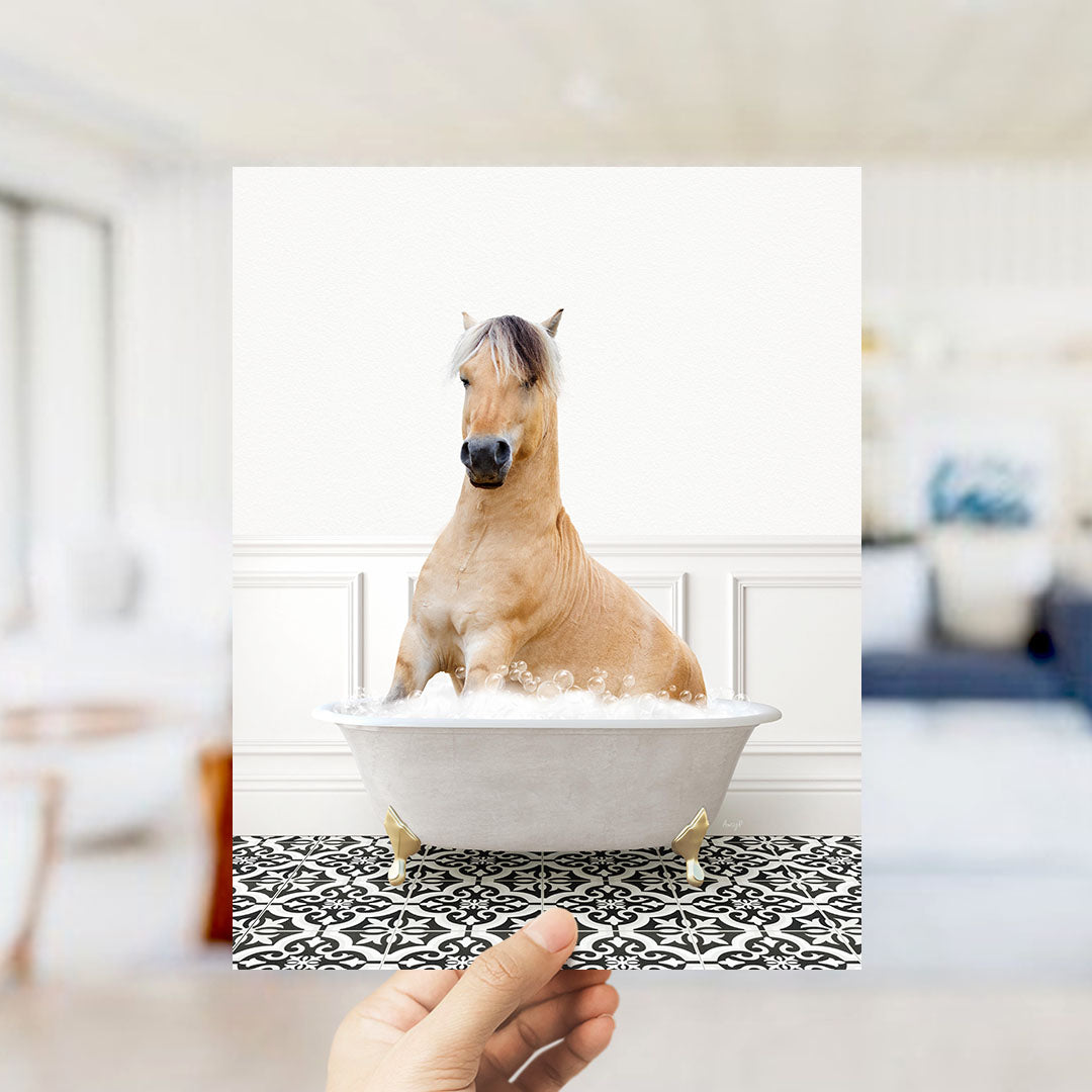 A light brown horse sitting in a white bathtub filled with water, surrounded by a black and white patterned floor.