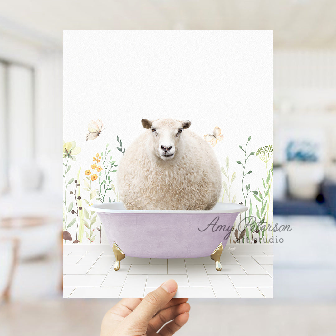 a hand holding a card with a sheep in a bathtub