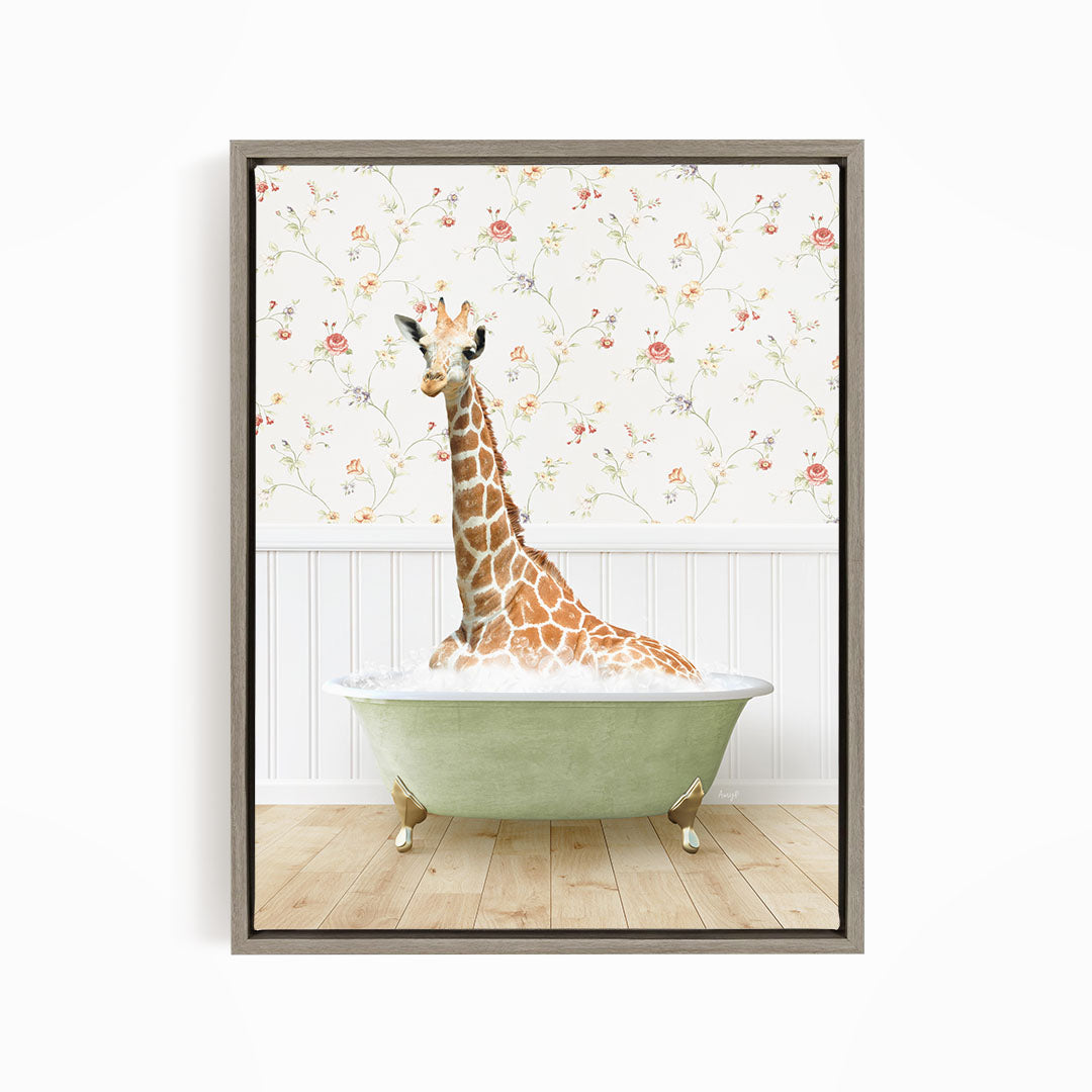 A giraffe is sitting in a green bathtub, surrounded by a floral wallpaper.