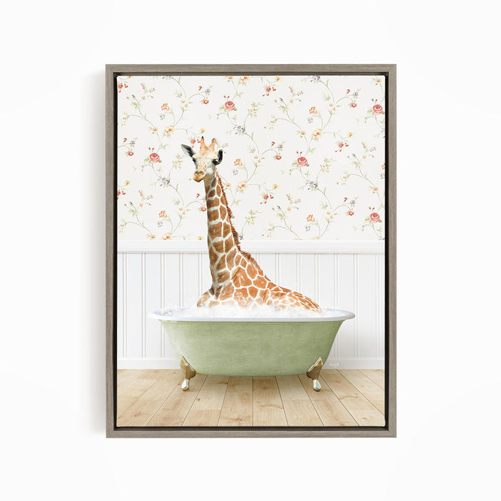 A giraffe is sitting in a green bathtub, surrounded by a floral wallpaper.