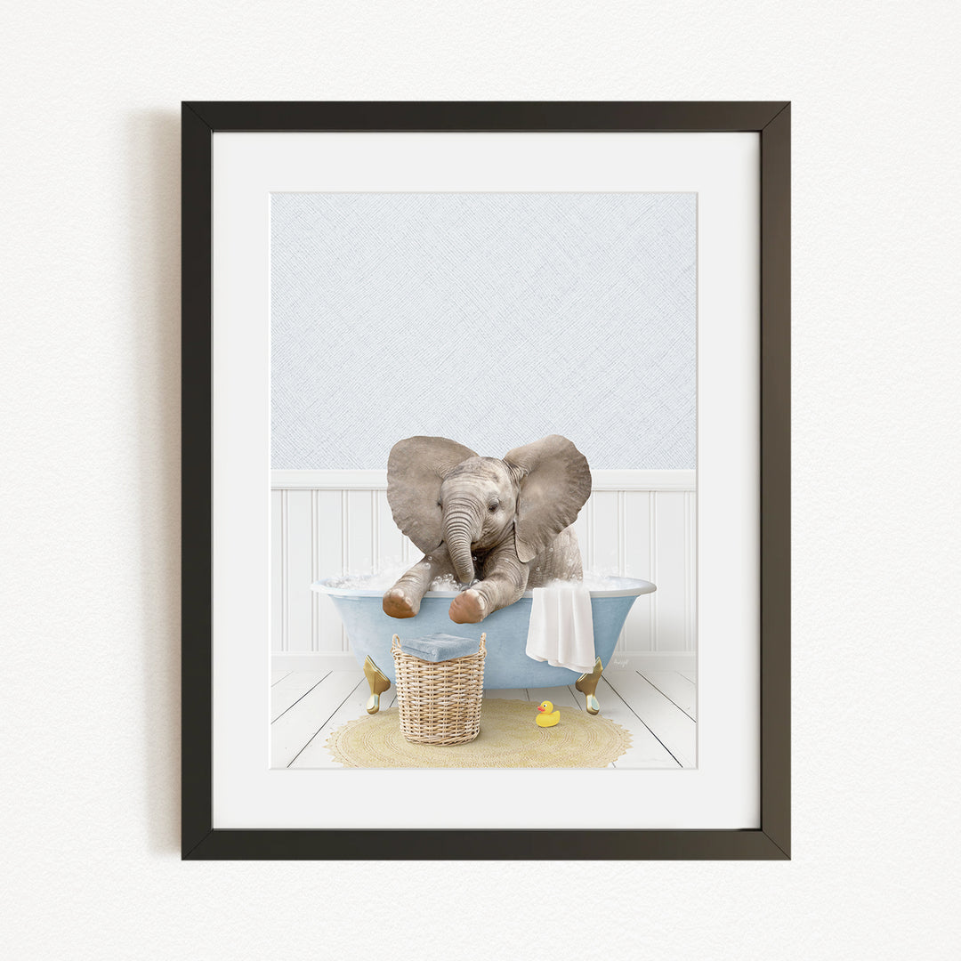 A baby elephant sitting in a blue bathtub, surrounded by yellow rubber duckies and a basket.