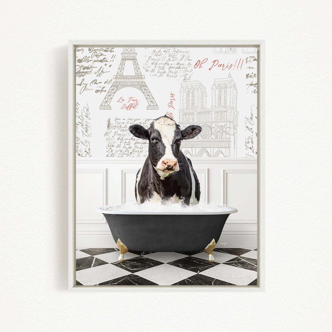 A black and white cow is sitting in a bathtub filled with water, with a Paris-themed background behind it.