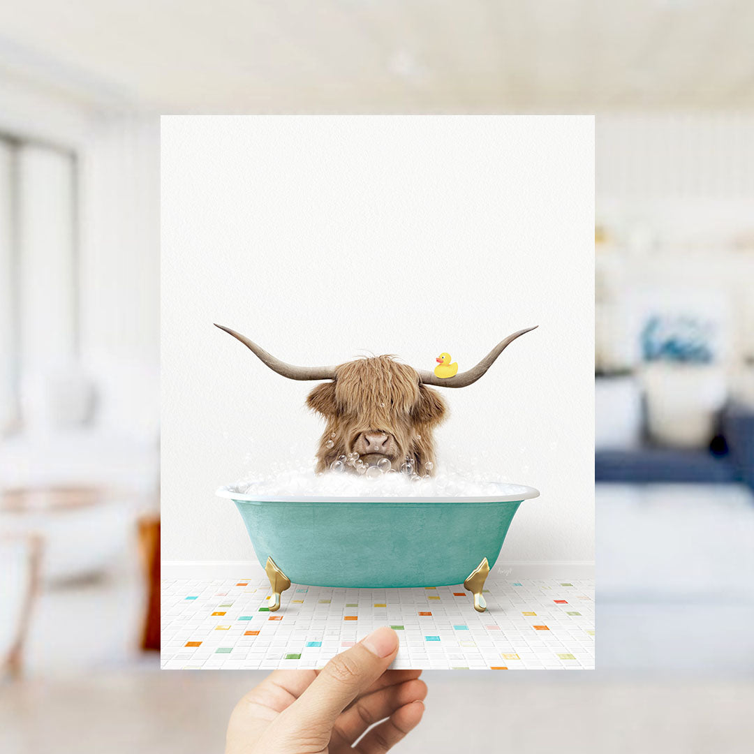 A Highland cow with large horns is sitting in a blue bathtub filled with bubbles, with a rubber duck floating on the water.