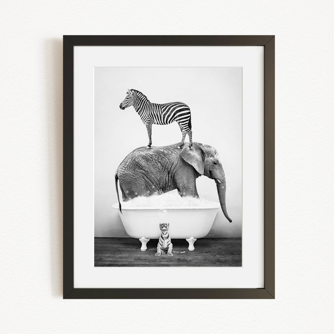 A zebra stands atop an elephant in a bathtub, with a small tiger sitting in the tub below.