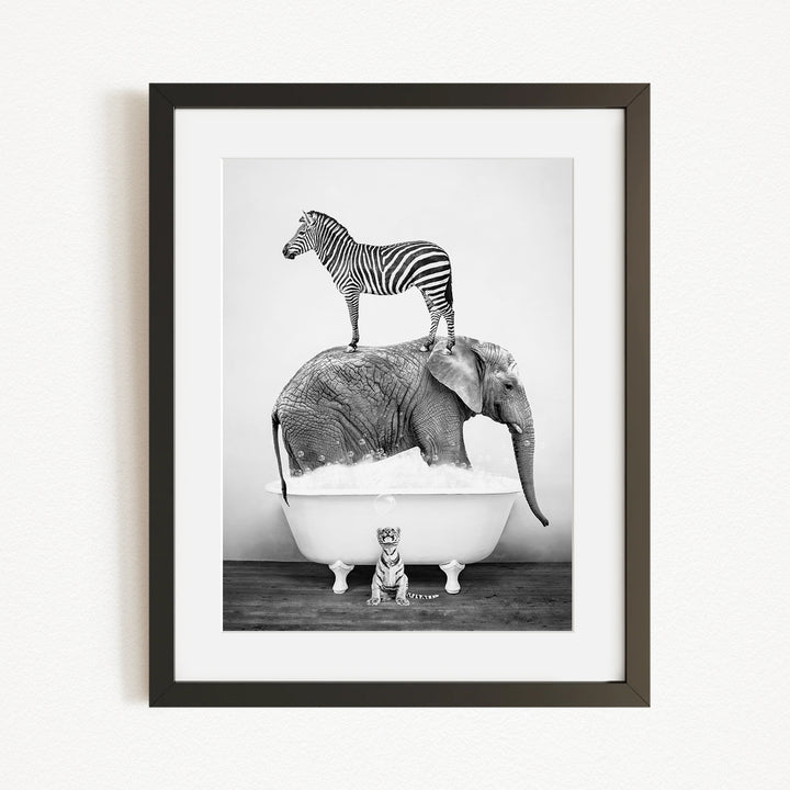 A zebra stands atop an elephant in a bathtub, with a small tiger sitting in the tub below.