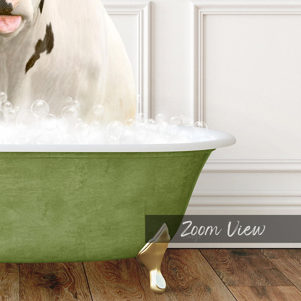 A white cow is sitting in a green bathtub filled with bubbles, with a wooden floor visible in the background.