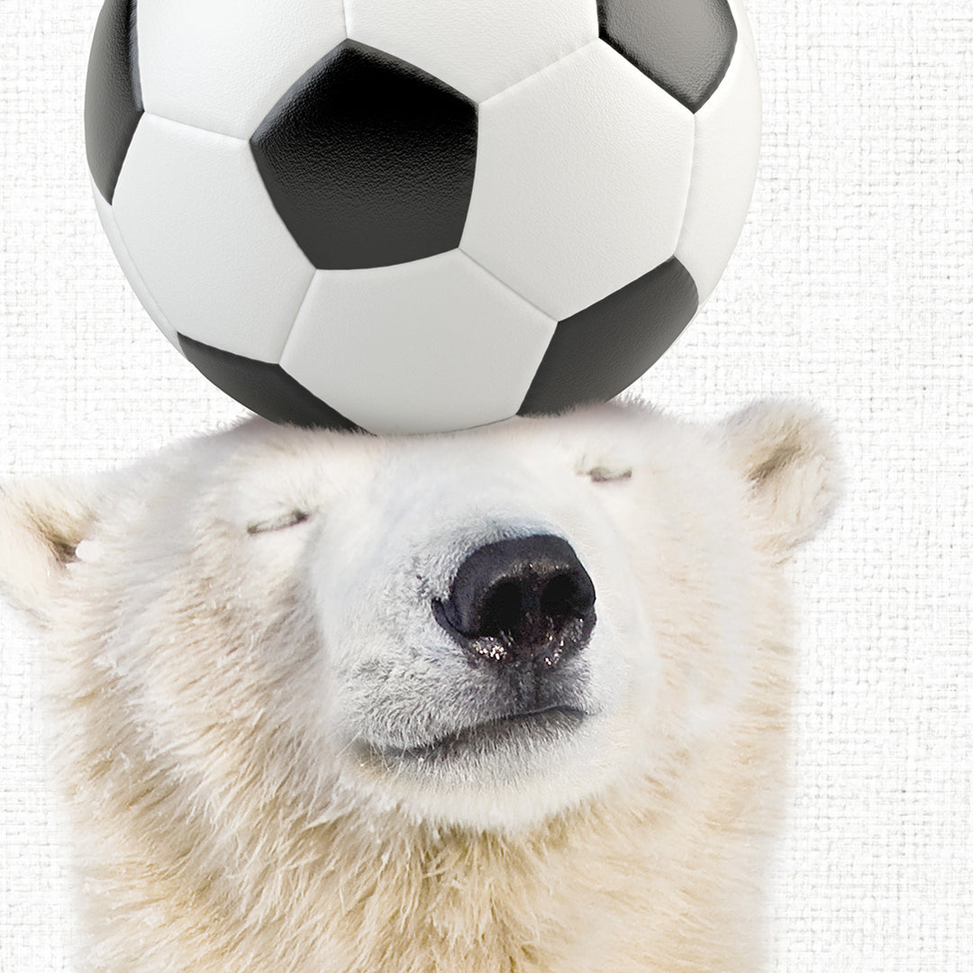 a polar bear balancing a soccer ball on its head