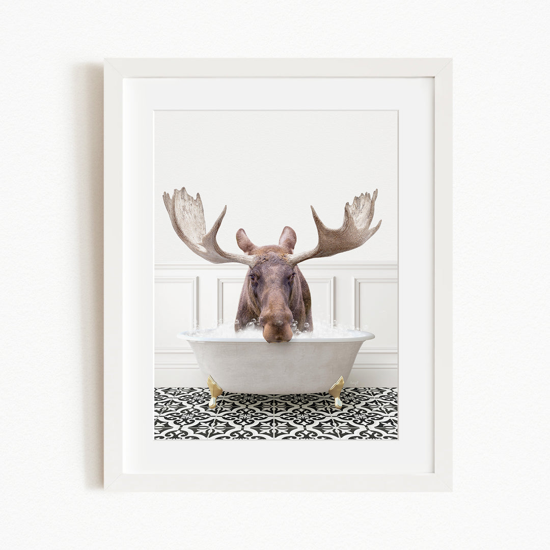A moose with large antlers is sitting in a bathtub filled with water, creating a whimsical and humorous scene.