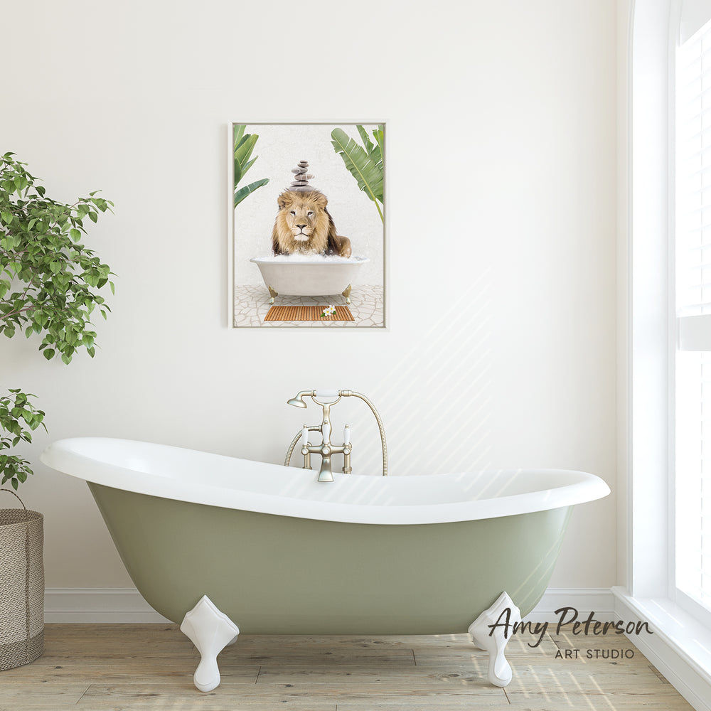 A green clawfoot bathtub sits in a bright, airy bathroom, with a framed image of a lion sitting in a bathtub hanging on the wall above it.