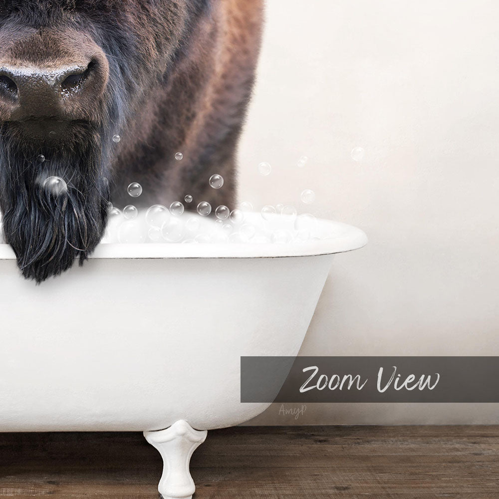 A close-up of a dog's face peeking out of a white bathtub filled with bubbles, with the text "Zoom View" overlaid on the image.