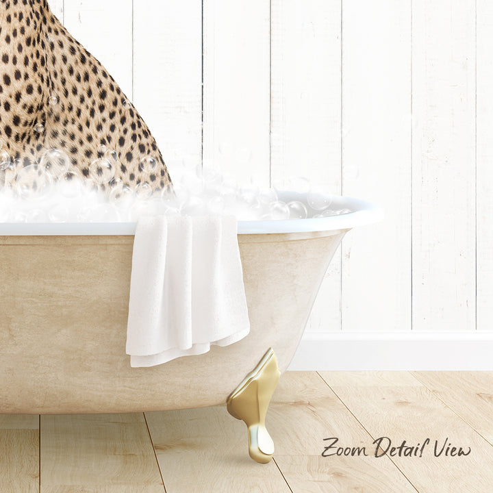 A leopard print towel is draped over the edge of a white clawfoot bathtub, with a wooden floor and white wall in the background.