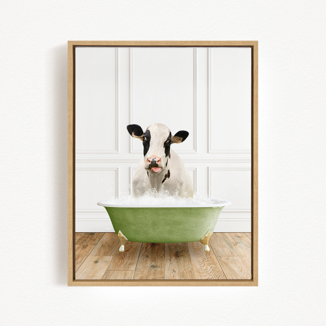 A black and white cow is sitting in a green bathtub filled with water, with its head above the water's surface.