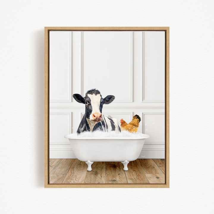 A black and white cow is sitting in a white bathtub, with a chicken nearby, in a white-walled room.