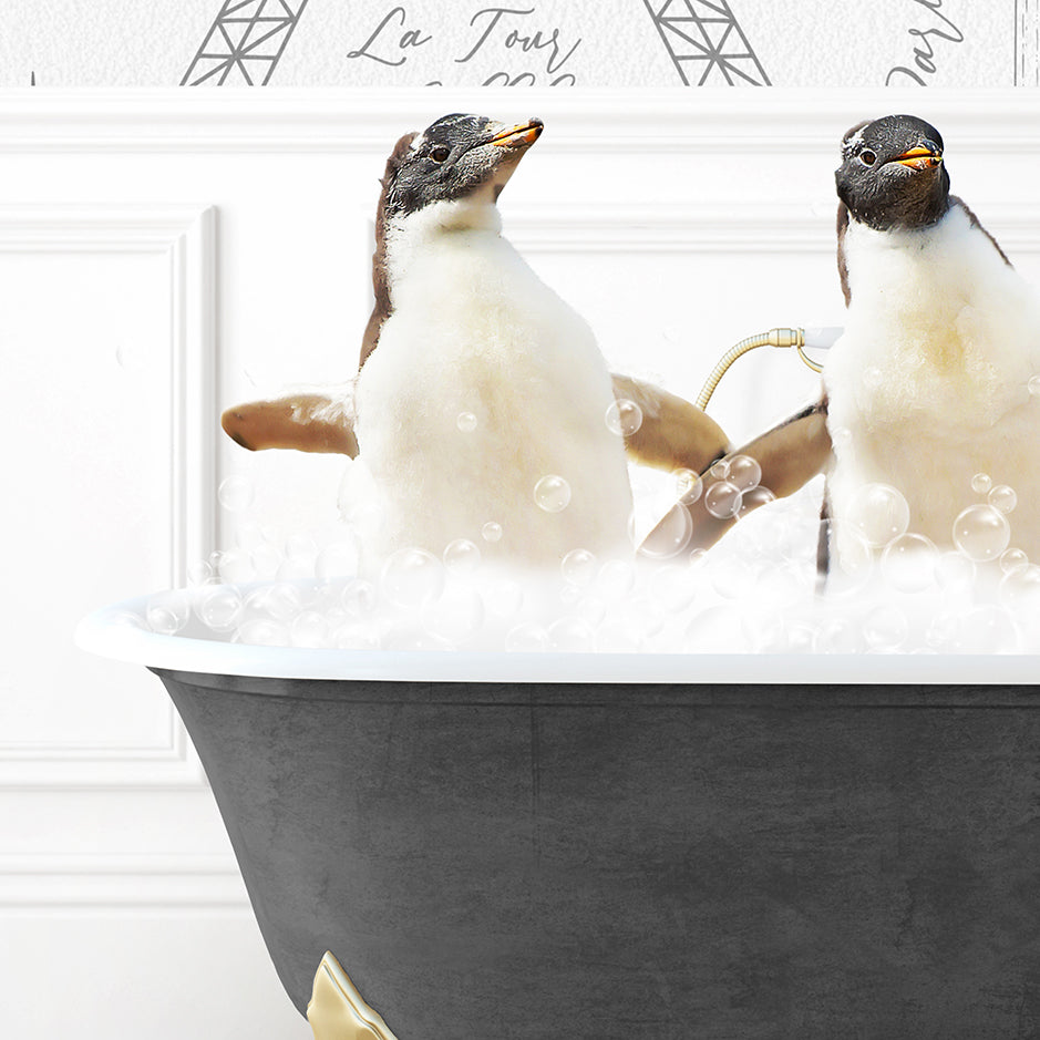 two penguins sitting in a bathtub with bubbles