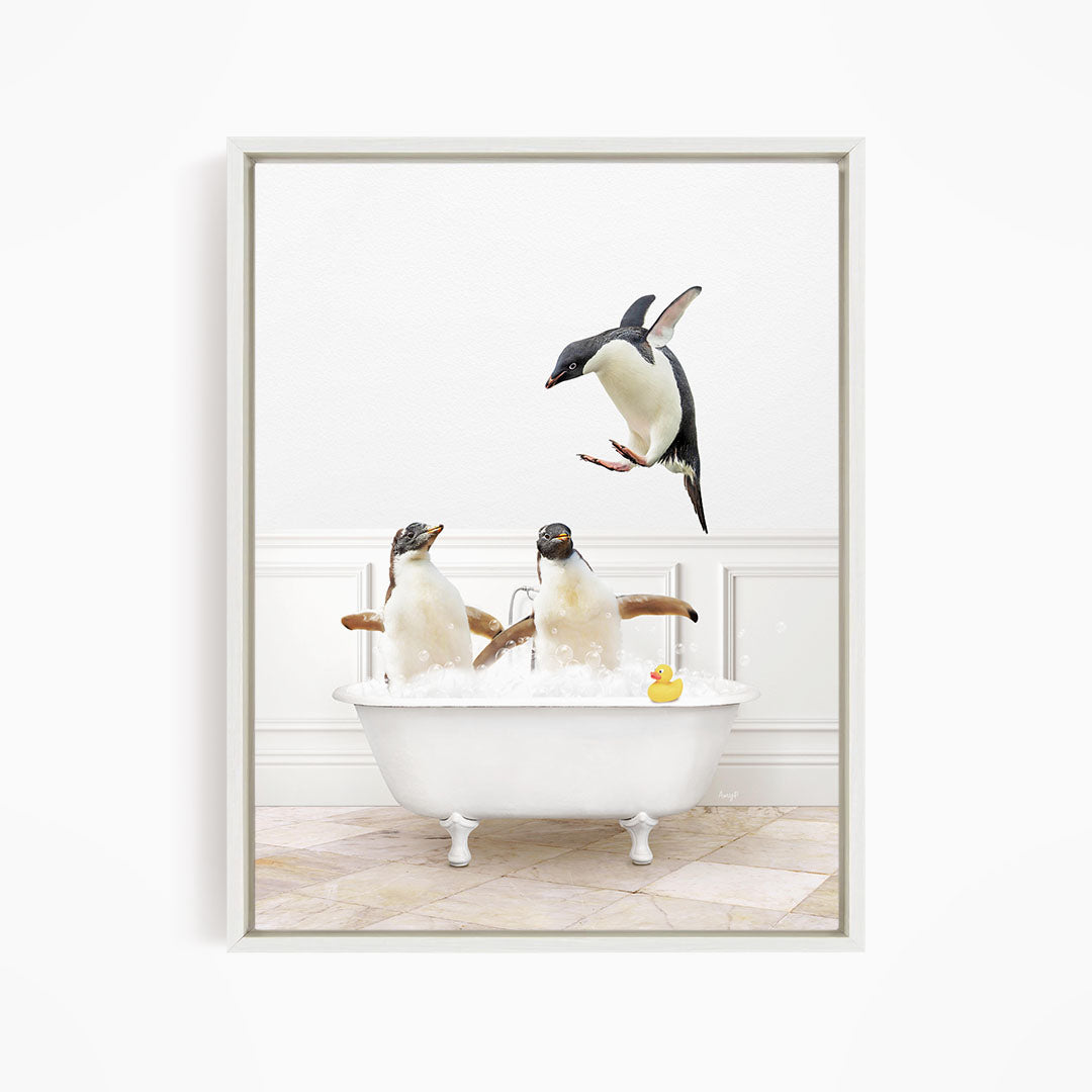 A framed image depicting three penguins sitting in a bathtub, with one penguin flying towards the others.