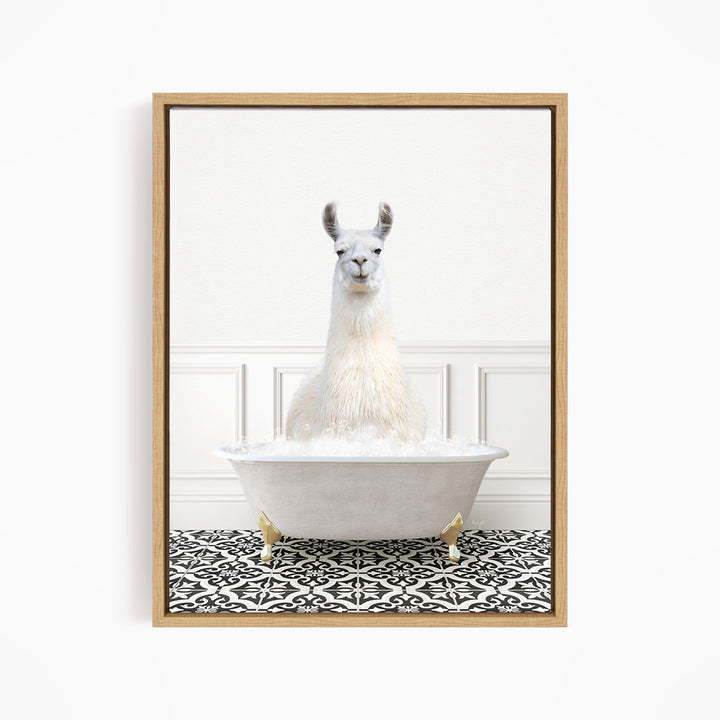 A white llama sitting in a white bathtub filled with bubbles, surrounded by a black and white patterned floor.