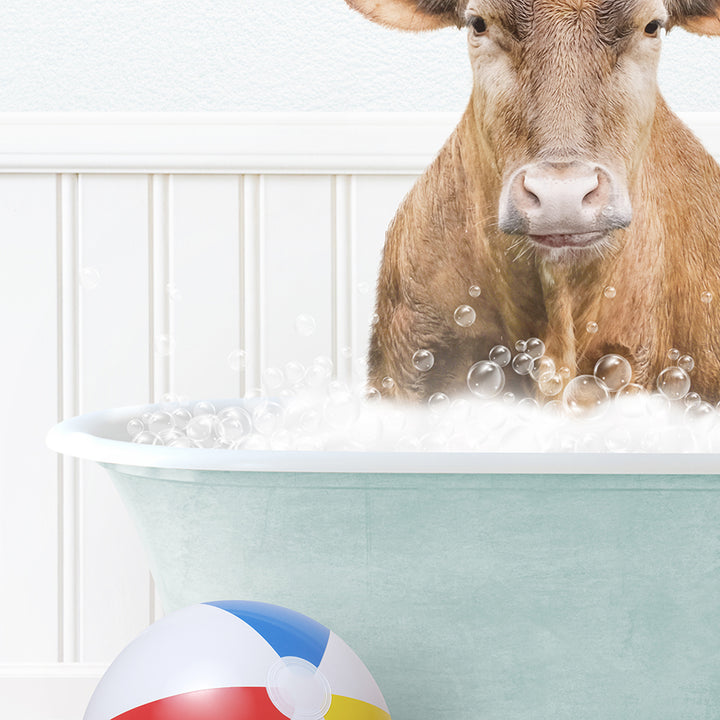 a cow sitting in a bathtub with bubbles and a beach ball