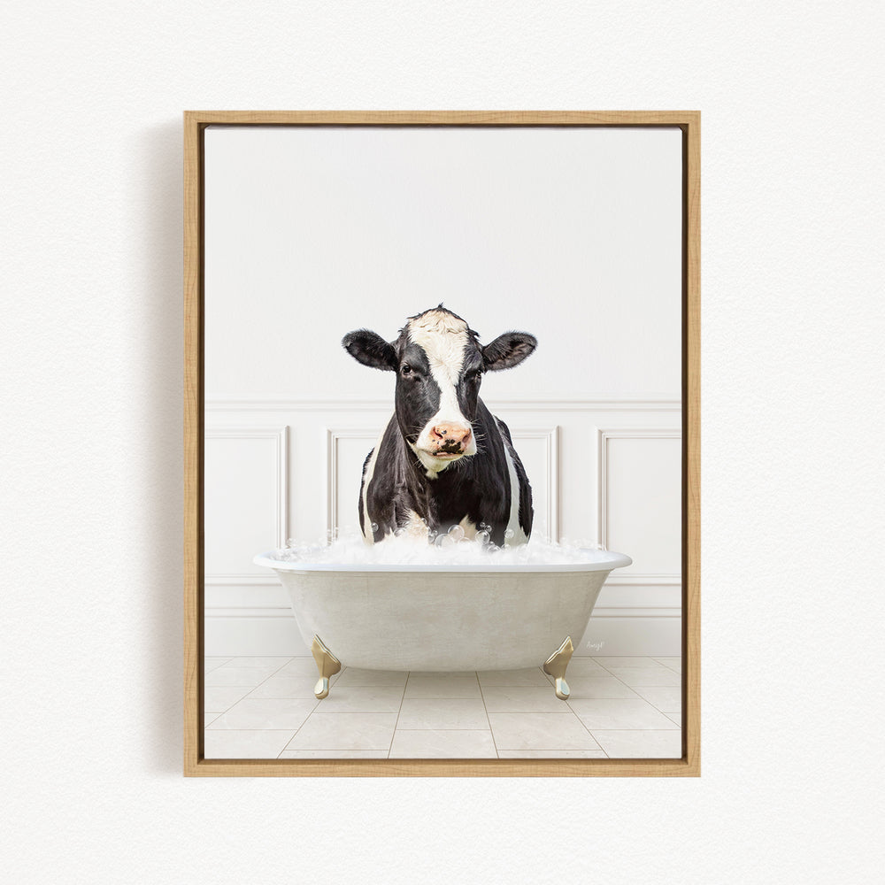 A black and white cow is standing in a white bathtub filled with water, creating a humorous and whimsical scene.