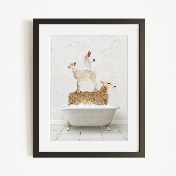A framed image depicting a goat standing on a sheep's back while a rooster sits on top of a sheep in a bathtub.