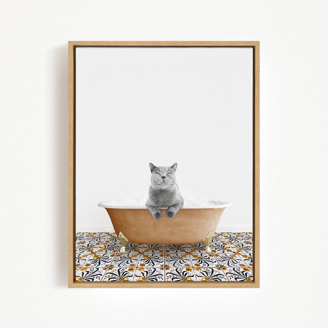 A gray cat sitting in a bathtub filled with bubbles, surrounded by a patterned tile floor.