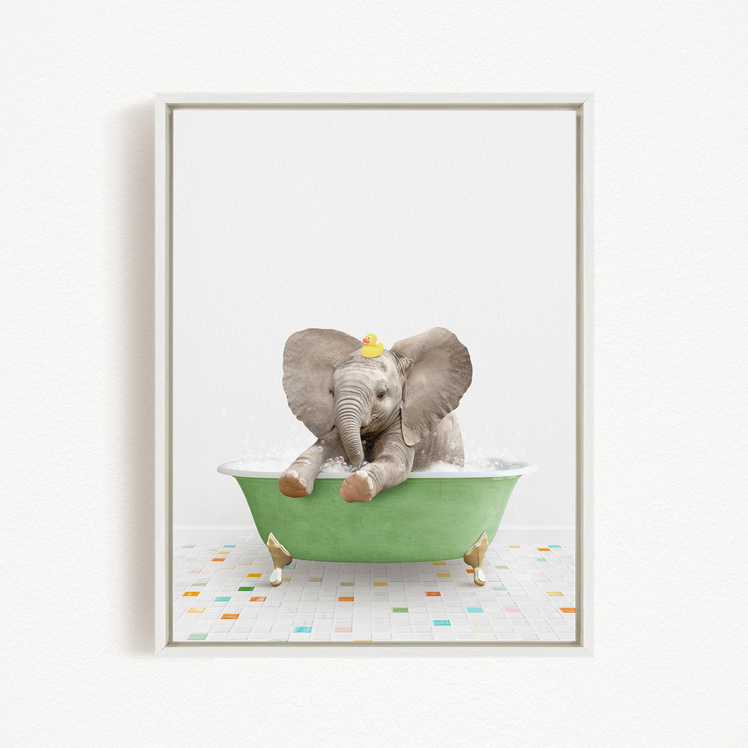 A baby elephant sitting in a green bathtub, with its trunk in the water and a yellow rubber duck floating on its head.