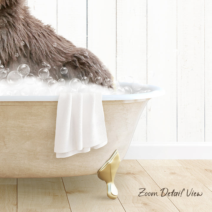 A fluffy brown dog is sitting in a bathtub filled with bubbles, with a towel draped over the side and a wooden floor visible in the background.