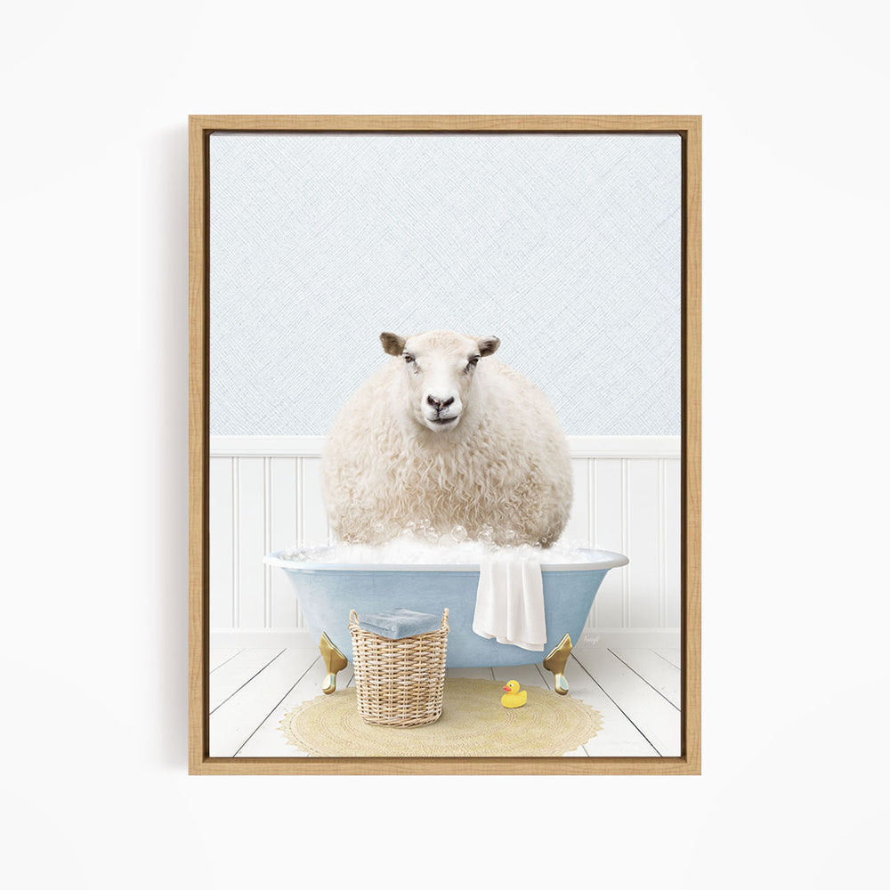 A fluffy white sheep sits in a blue bathtub filled with bubbles, surrounded by a basket of bath toys and a yellow rubber duck.