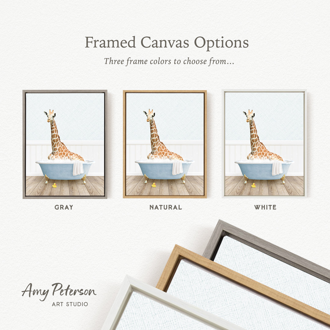 The image is a framed canvas option featuring three different colored frames, each containing a painting of a giraffe sitting in a bathtub.