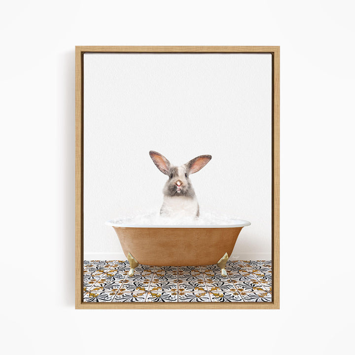 A white rabbit with brown ears is sitting in a bathtub filled with water, looking up at the camera.