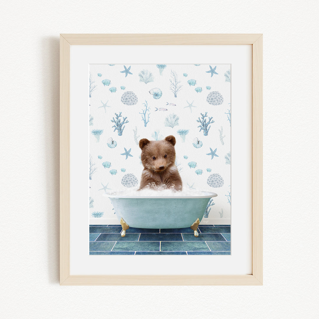 A cute brown bear sitting in a blue bathtub, surrounded by a pattern of seashells, starfish, and other marine life.