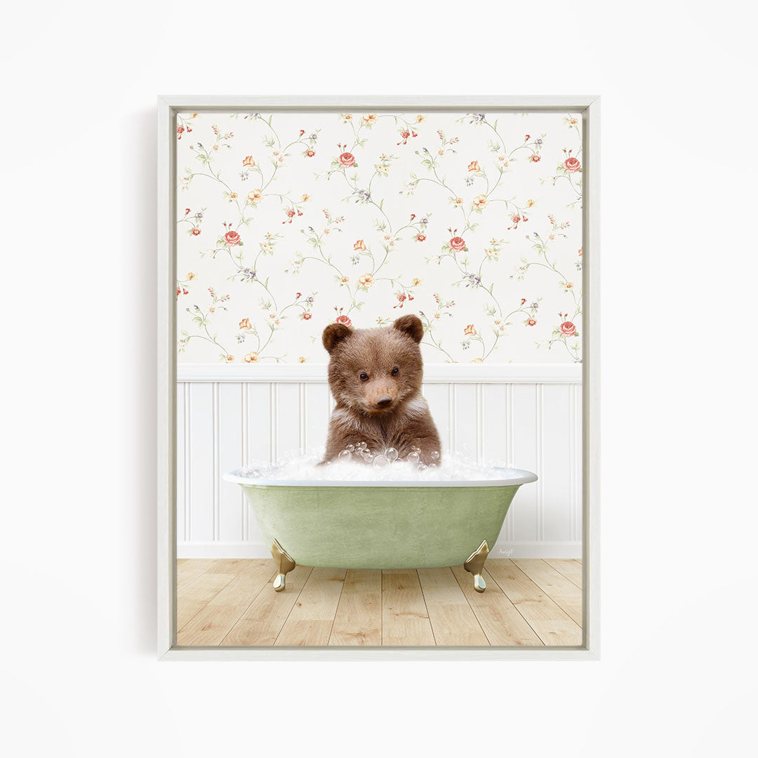 A brown bear sitting in a green bathtub filled with water, with a floral wallpaper in the background.