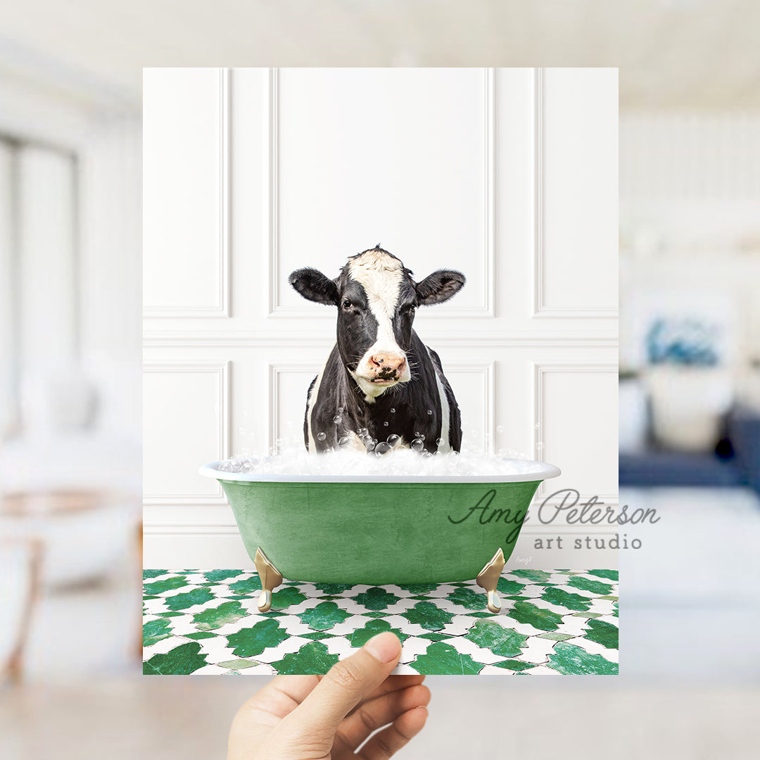 a hand holding up a card with a picture of a cow in a bathtub