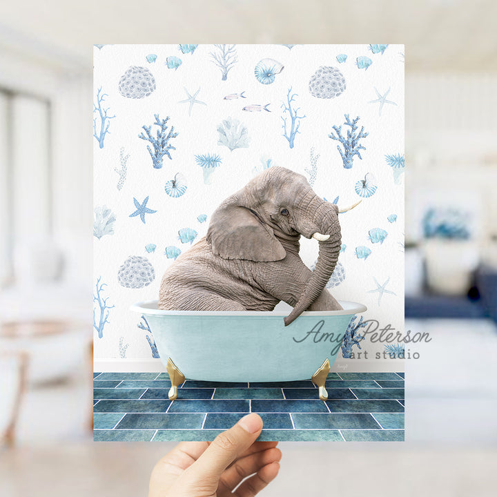 a person holding up a picture of an elephant in a bathtub