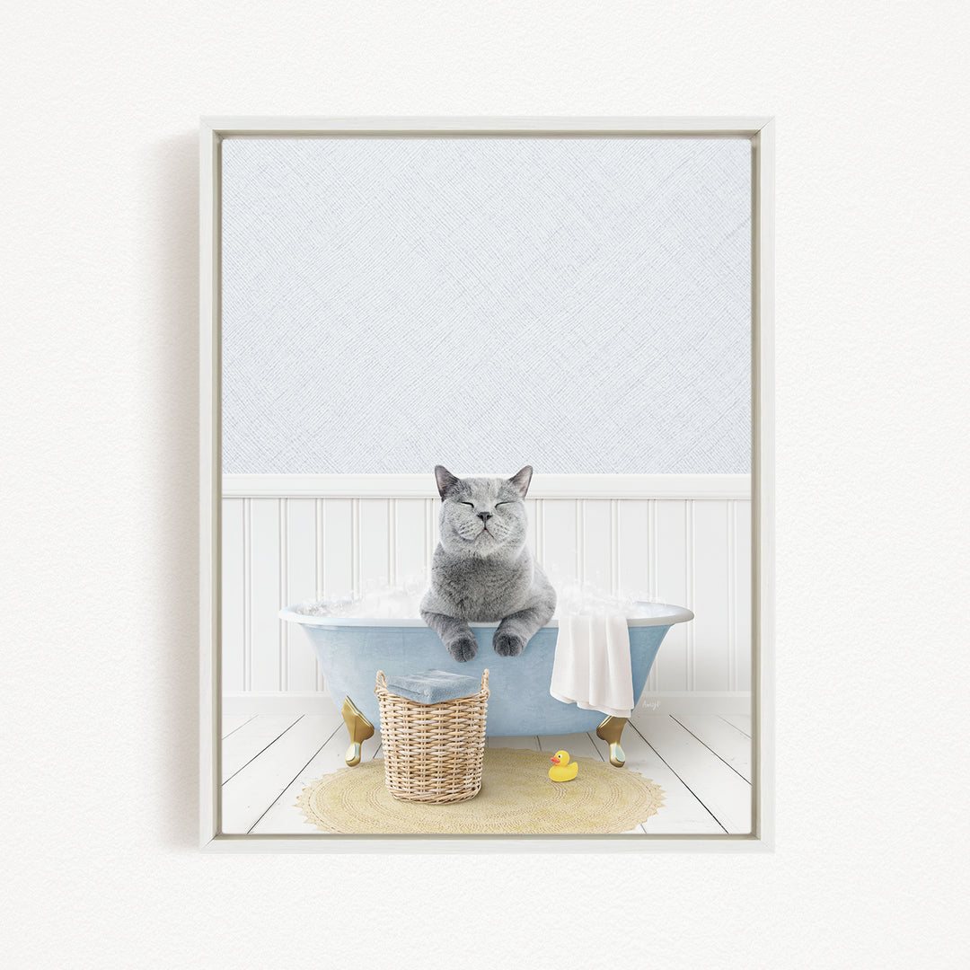 A gray cat sitting in a blue bathtub filled with water, surrounded by a yellow rubber duck and a basket.