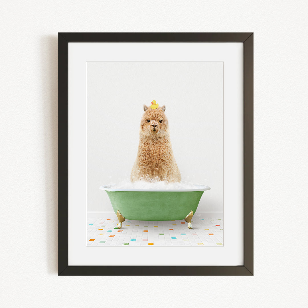 A brown alpaca sitting in a green bathtub filled with bubbles, with a yellow duck perched on its head.