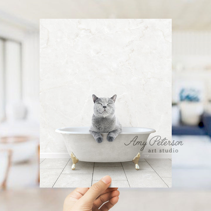 a hand holding a card with a cat in a bathtub