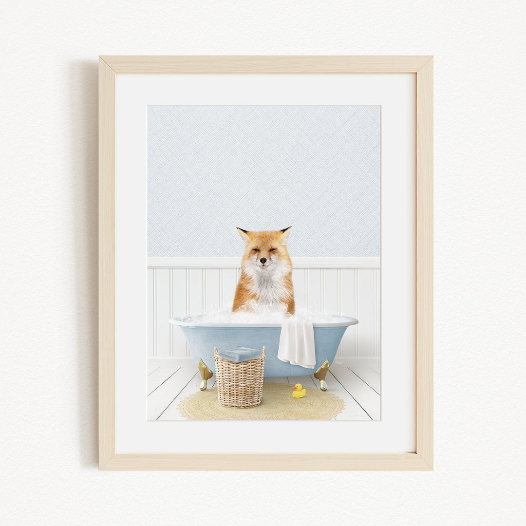 A red fox is sitting in a blue bathtub filled with bubbles, surrounded by rubber ducks and a basket.