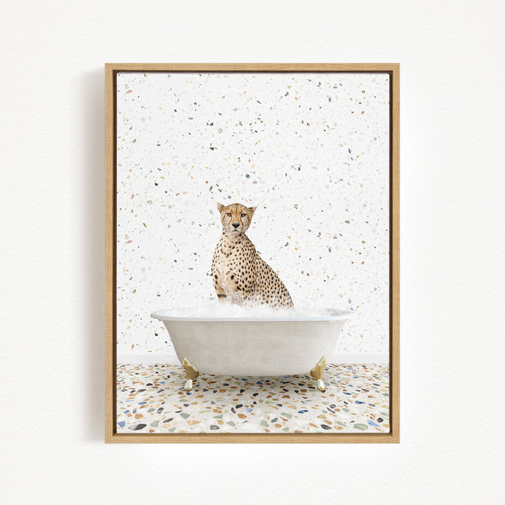 A cheetah sitting in a white bathtub filled with water, surrounded by a speckled tiled floor.