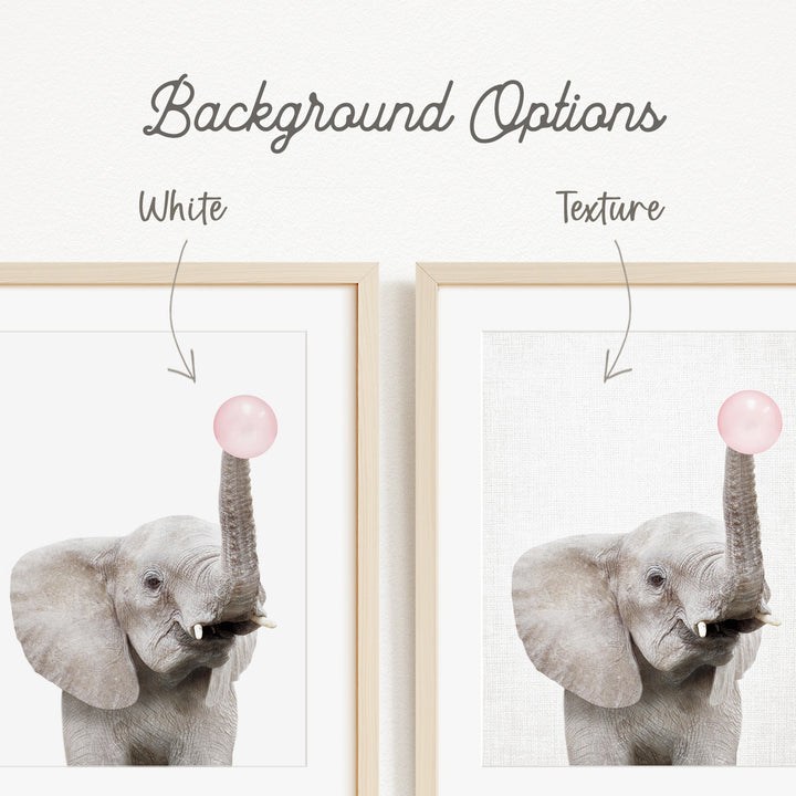 a gray elephant holding a pink bubble in its trunk.