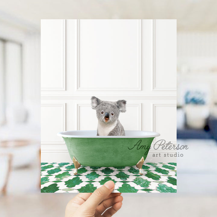 a hand holding a card with a picture of a koala in a bathtub